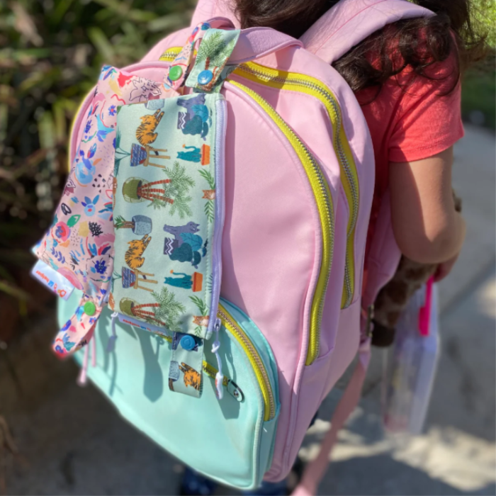 reusable snack bags on a child’s backpack